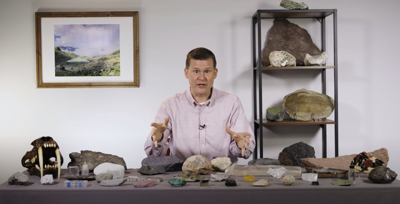 Ethan Baxter in recording studio surrounded by fossils and rocks